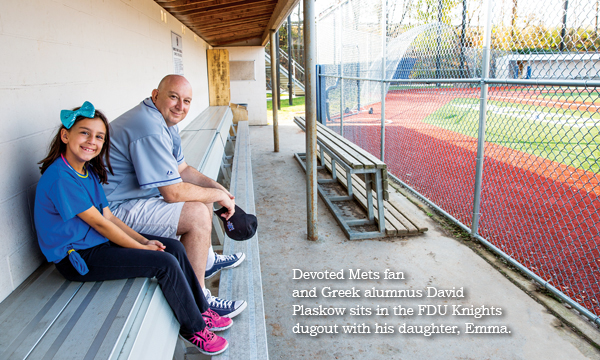 Image: Devoted Mets fan and Greek alumnus David Plaskow sits in the Knights dugout with his daughter, Emma.